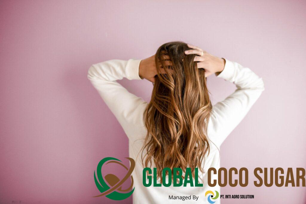 woman in white long-sleeved shirt standing in front of pink wall