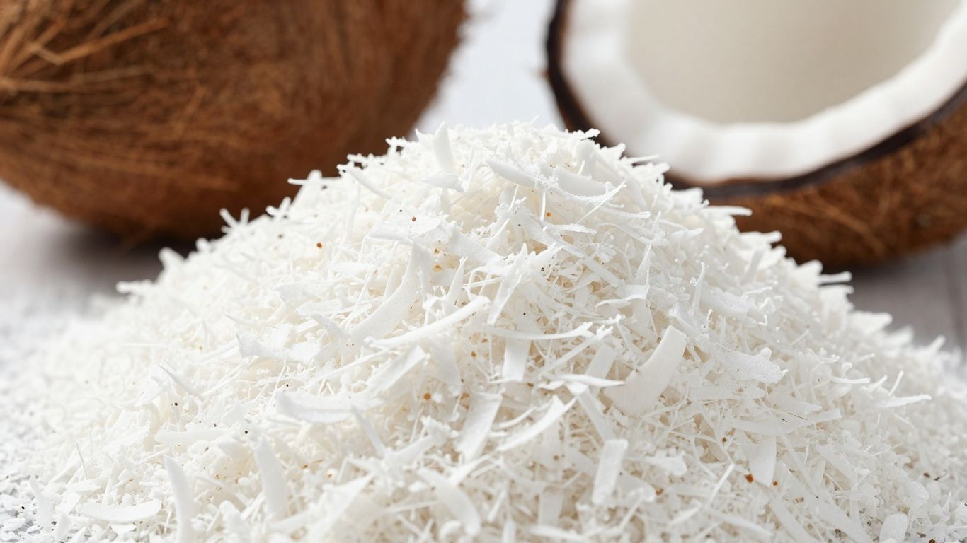 Desiccated coconut flakes and whole coconuts