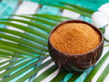 Coconut brown sugar in a wooden bowl. Tropical background coconut brown sugar, vanilla coconut sugar, coconut stevia, coconut sweetener