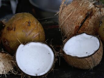 white round ornament on brown wooden round container, organic desiccated coconut, unsweetened desiccated coconut, desiccated coconut powder, fine shredded coconut